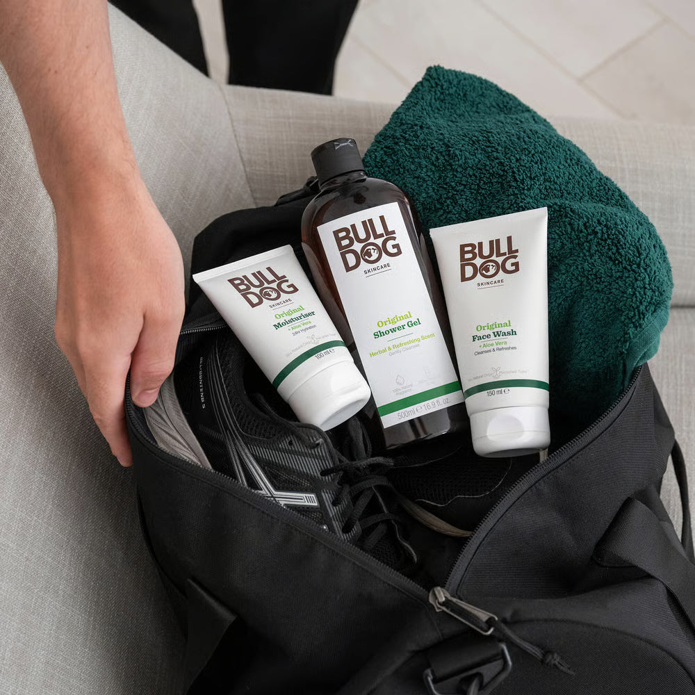 Bulldog grooming products including shower gel, face wash, and towel in a bag.
